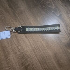 Lululemon Black and Gold Never Lost Keychain